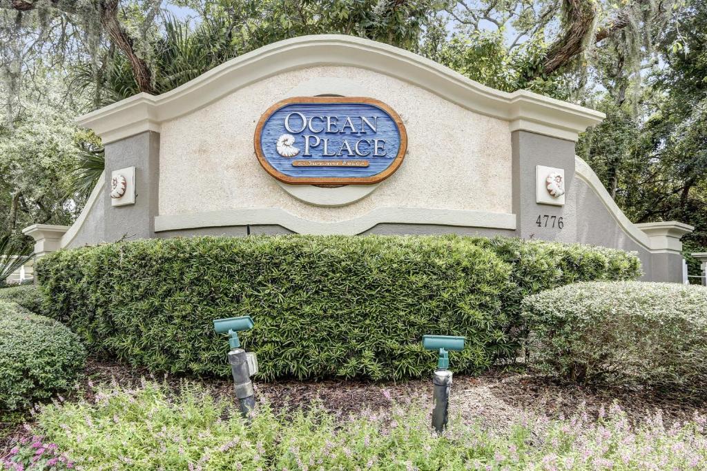 a building with a sign for an ocean place at Beautiful Oceanfront Getaway w/Shared Pool, Central AC, Elevator, & W/D in Fernandina Beach