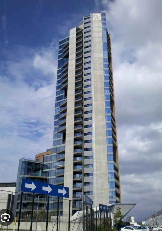 a tall building with blue and white signs on it at Modern apartment in Angelopolis - 2 bedrooms in Tlazcalancingo