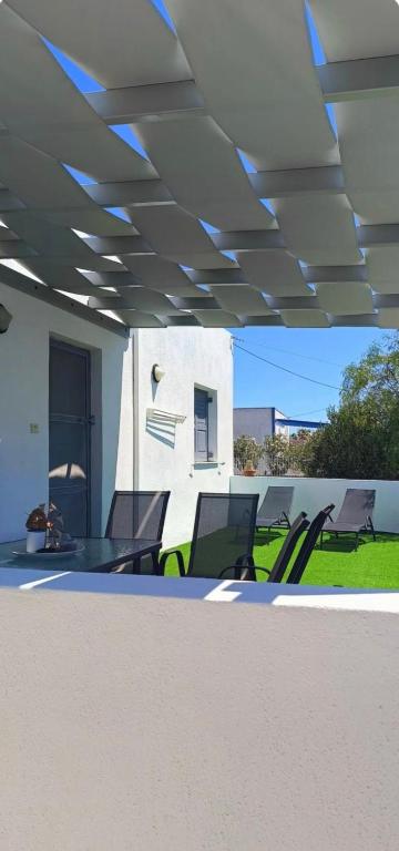 a group of chairs sitting under a ceiling at Elli's House in Perivolos