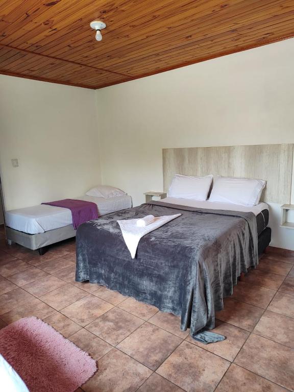 a bedroom with two beds and a wooden ceiling at Mariposa 88 in Puerto Rico