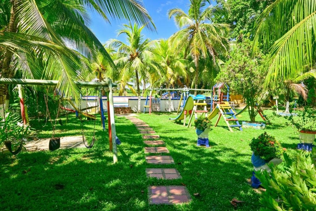 a park with a playground with palm trees at El Ranchito de Turbo in Turbo