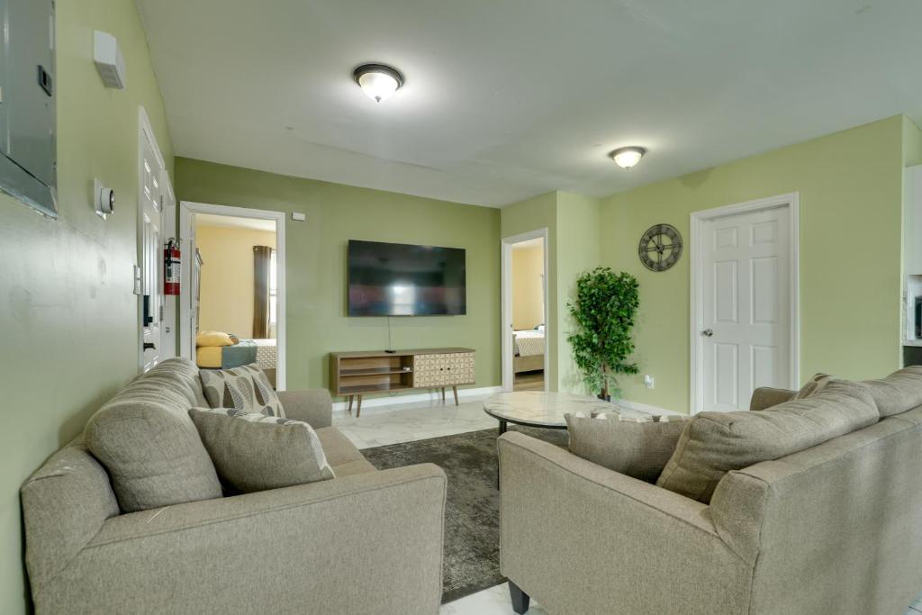 a living room with two couches and a tv at Explore NYC, Parks & Beaches! Top-Floor Apt in Mount Vernon