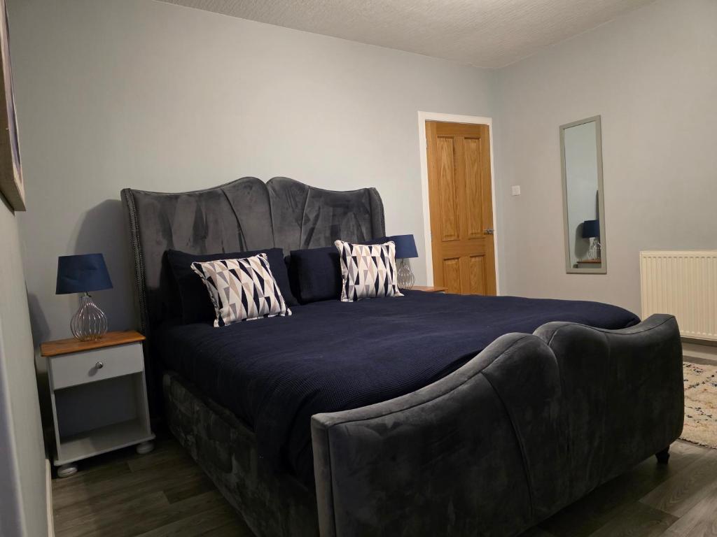 a bedroom with a large bed and a couch at Wick Harbour View Apartment - 2 Beds - Sleeps 3 - Ideal for Couples in Wick