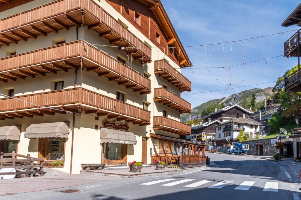 a building with wooden balconies on the side of a street at HelloChalet - Chez León in Valtournenche