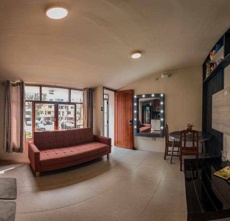 a living room with a couch and a table at Apartment E18 UPAO 2nd Floor in Trujillo
