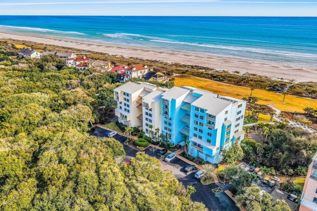 an aerial view of a building and the beach at Oceanfront condo with direct beach access, pool, balcony, grilling area, & AC in Fernandina Beach