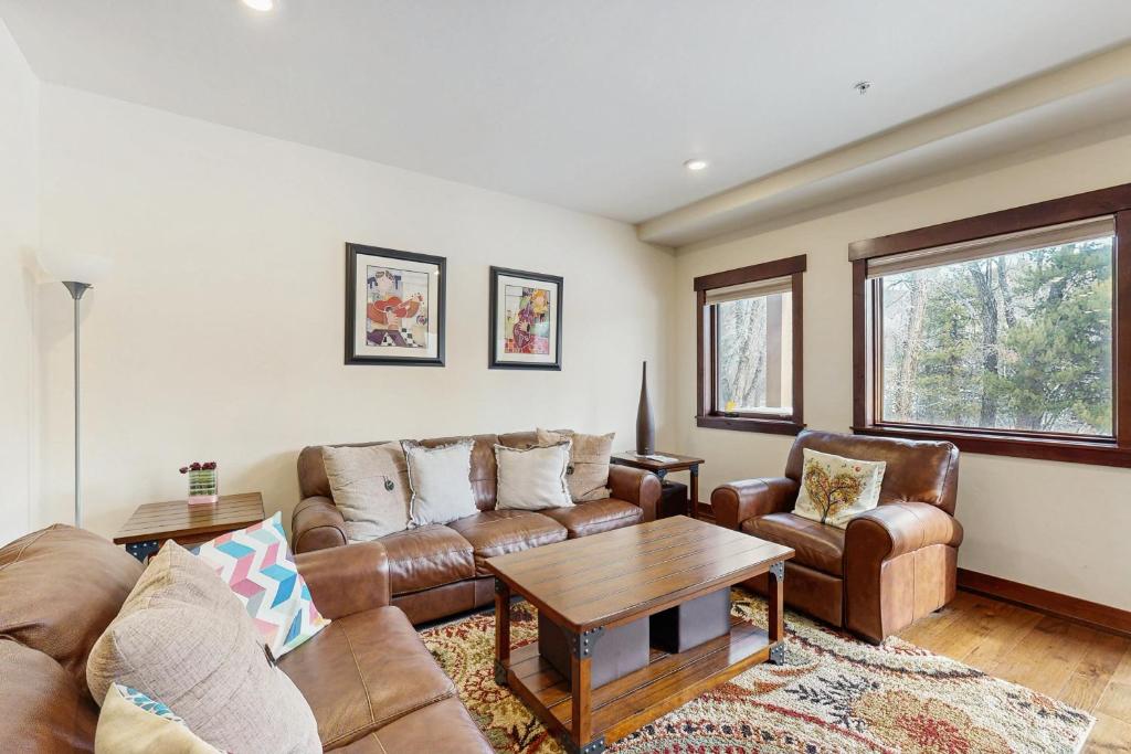 a living room with two couches and a table at Blue River Retreat in Silverthorne