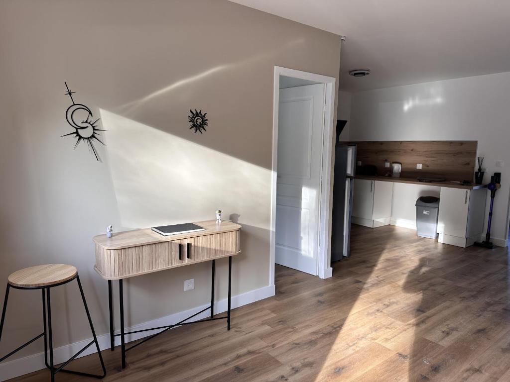 a room with a desk and a hallway with a staircase at L'abeille sous les étoiles in Saint-Michel-lʼObservatoire