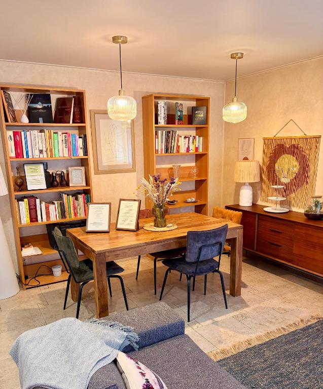 a living room with a wooden table and chairs at CASA BIANCA MAISON BLANCHE in Saint-Florent