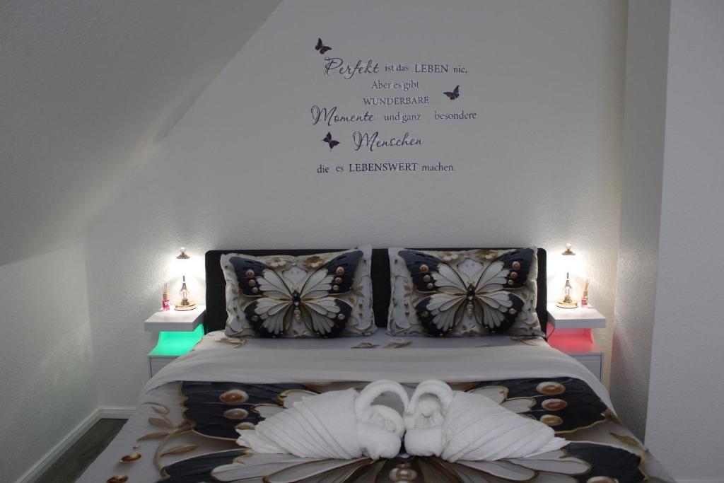 a bedroom with a bed with two flip flops on it at Gemütliche Wohnung in Mendig in Mendig
