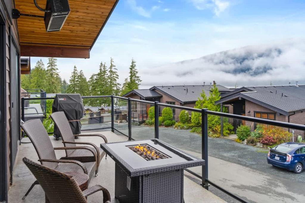 a patio with a table and chairs on a balcony at Wild Beauty - Oceanview - Pet Friendly - sleep 2 in Port Renfrew