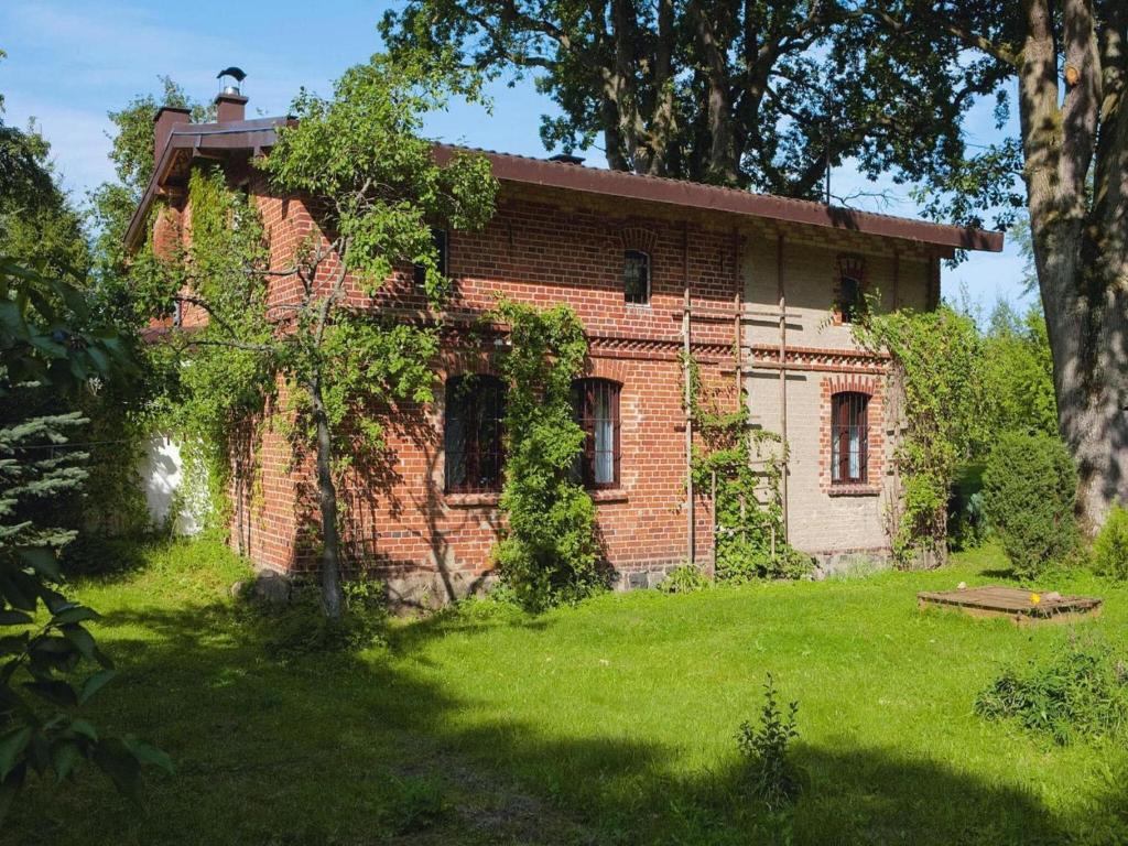 an old brick house with ivy growing on it at Large holiday home, summer pool, sauna, whirlpool in Sasino