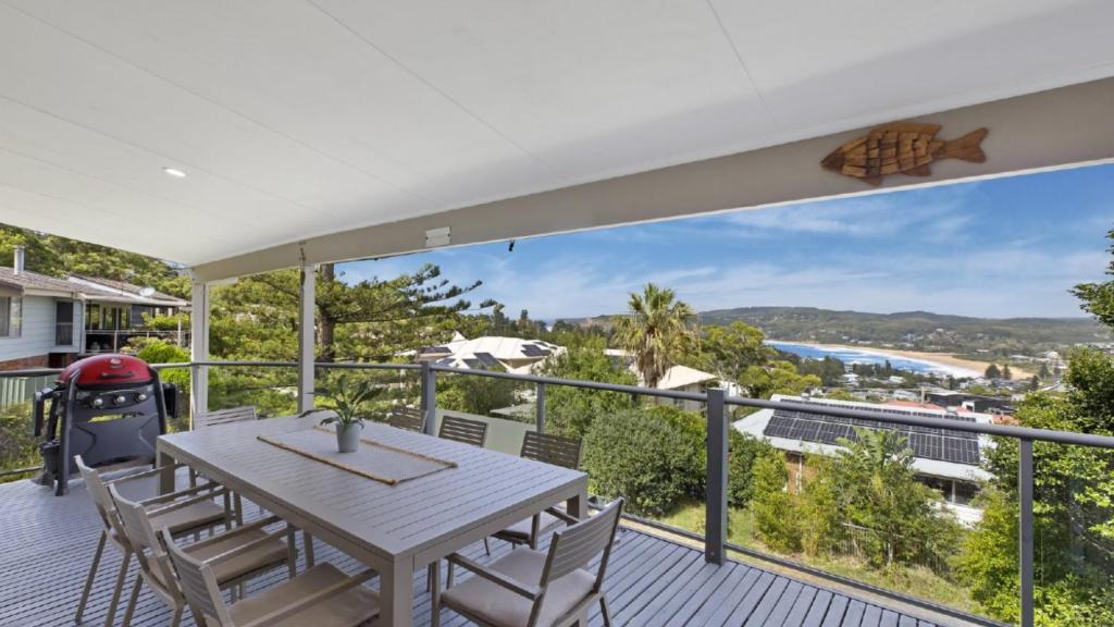 a balcony with a table and chairs and a view of the ocean at Copa Dell - Stunning Views in Copacabana