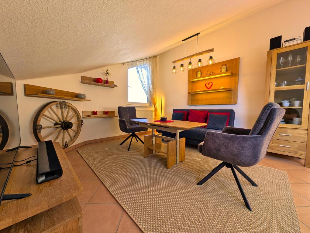 a living room with a wooden table and chairs at Ferienhaus Alexandra in Nesselwang