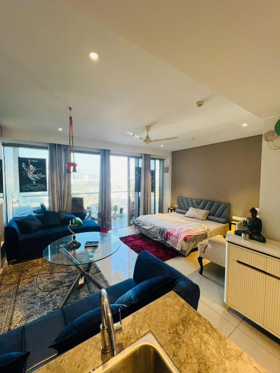 a large living room with a bed and a couch at Luxury Studios Key 7 in Gurgaon