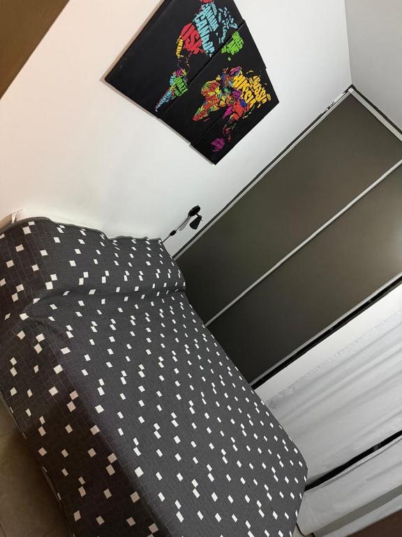 a bed in a room with a picture on the wall at Dpto en la costa in Villa María