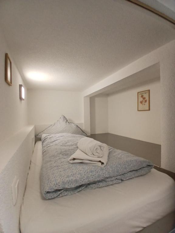 a bed with a towel laying on top of it at CUBE 5 New in Bad Saulgau