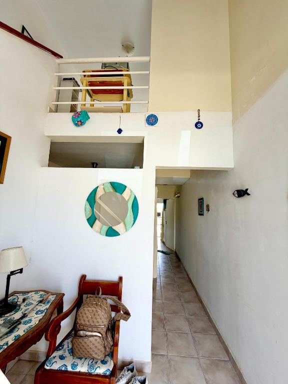 a living room with a chair and a table at Magos al sur Mare in Las Grutas