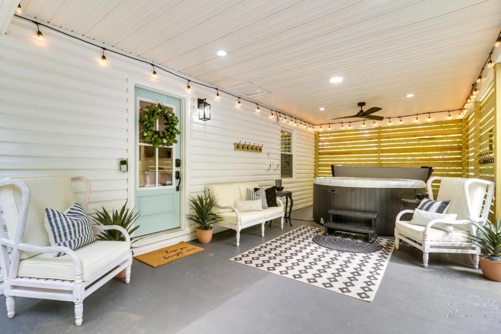 a patio with white chairs and a fireplace at Meme & Papas Compound 2 Homes, Hot Tub in Afton
