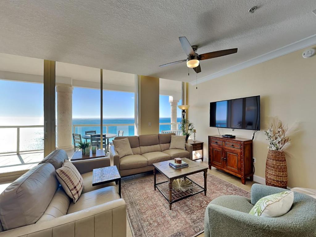 a living room with a couch and a flat screen tv at Beach Club #1605C in Pensacola Beach