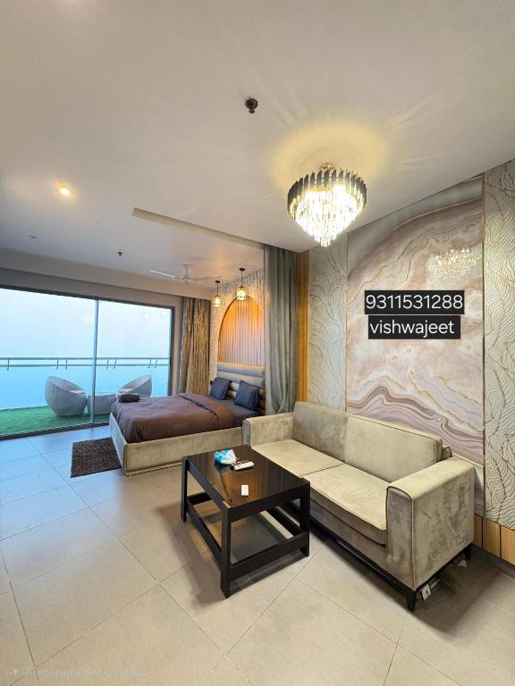 a living room with a couch and a bed at Spira staycation in New Delhi