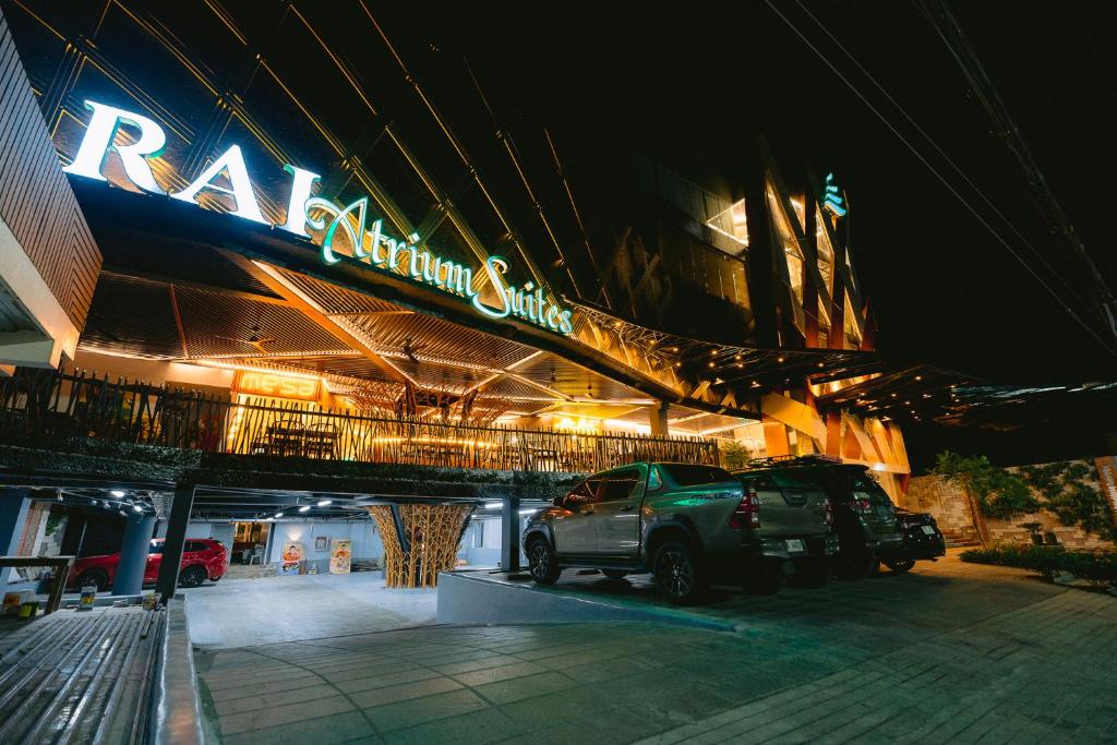a car parked in front of a building at night at RAI ATRIUM SUITES HOTEL - Cauayan in Cauayan City