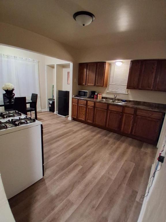 a kitchen with wooden floors and a stove top oven at GA home in Milwaukee
