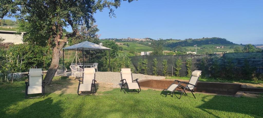 a group of chairs sitting in the grass at Cascina Danila in Narzole