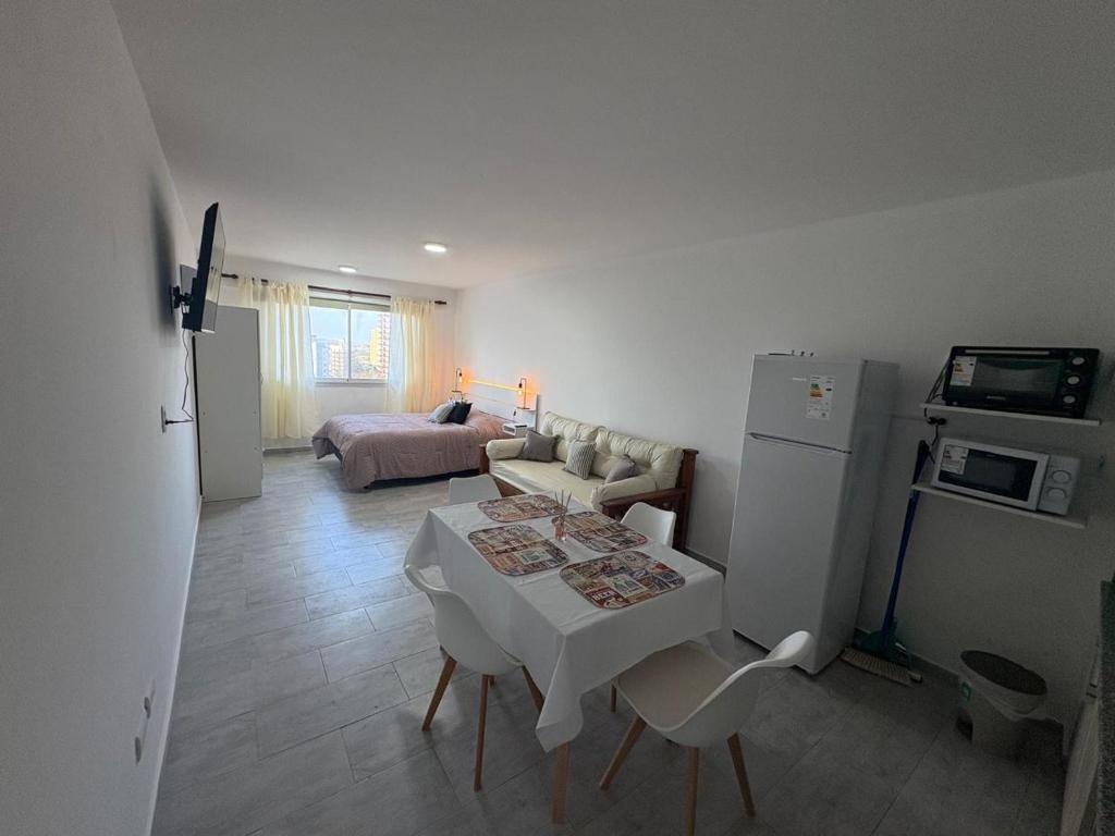 a living room with a table and a couch at Ambar Estudio in Miramar