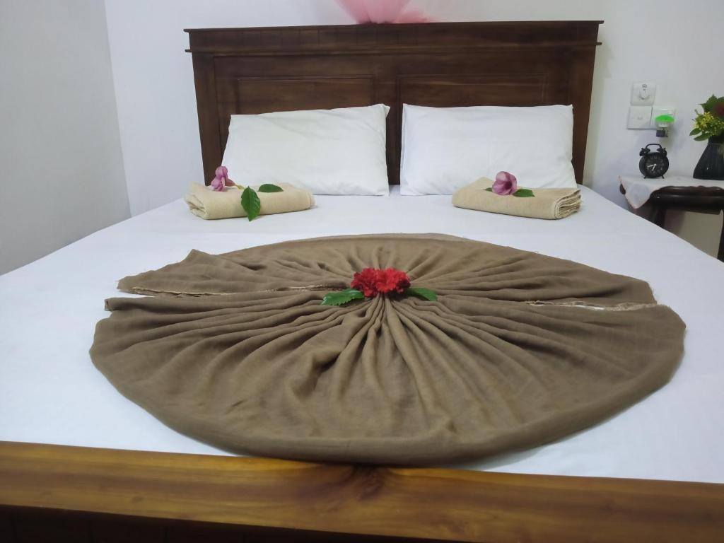 a bed with a blanket on top of it at Breeze House in Hikkaduwa