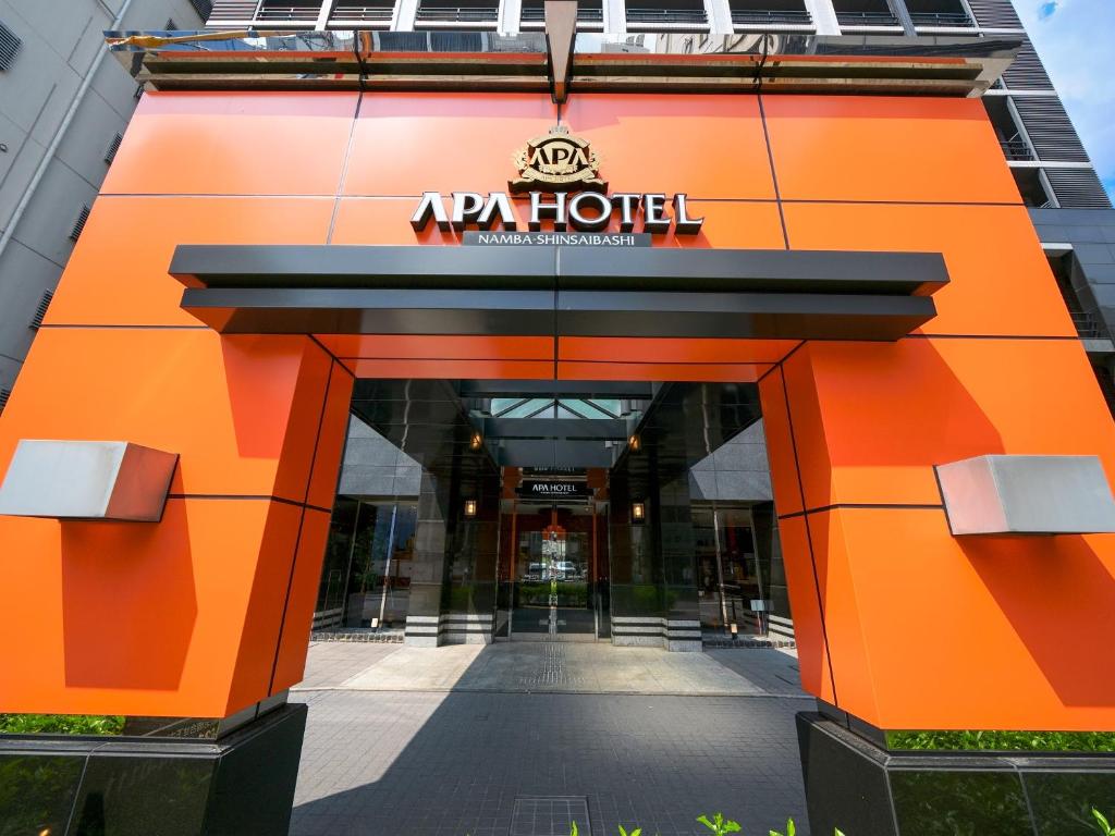 an entrance to a hotel with an orange building at APA Hotel Namba Shinsaibashi in Osaka