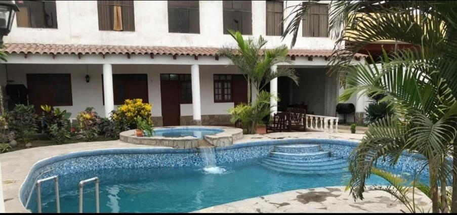 a swimming pool in front of a house at Modern Apartament Pool & Jacuzzi 2 room in Lima