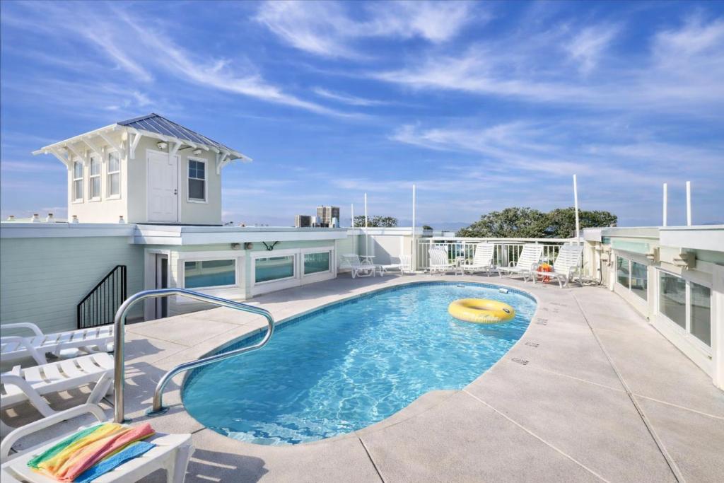 a swimming pool with a frisbee on a patio at Captains Watch in Tybee Island