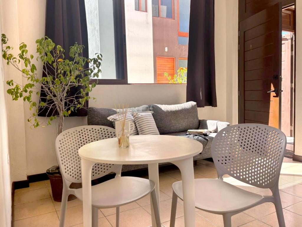 a living room with a table and chairs and a couch at Moro Apartments - Near the beach in Cancún