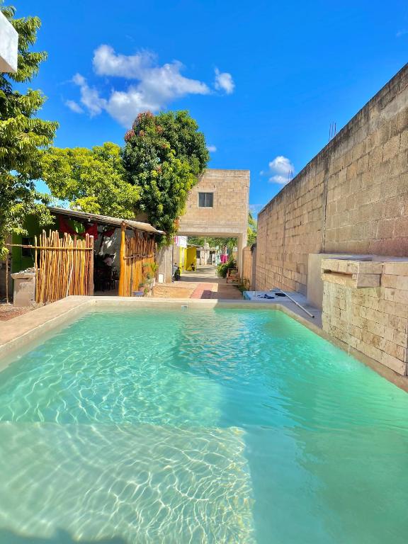 a large pool of water next to a brick wall at Casa Lol-cab Hostal in Valladolid