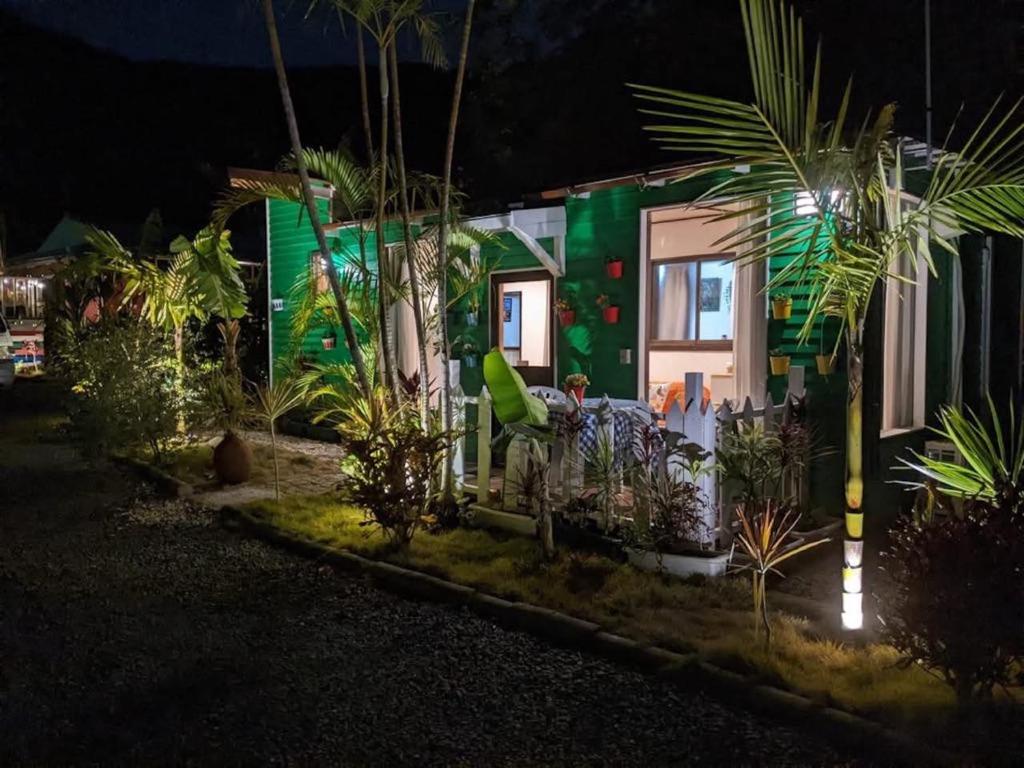 a house with a green facade at night at Art Bungalow Amami in Amami