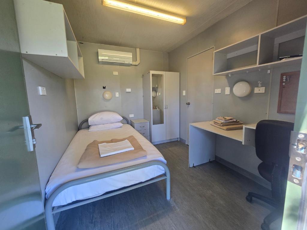 a small hospital room with a bed and a desk at Cheap Rooms North Brisbane in Narangba