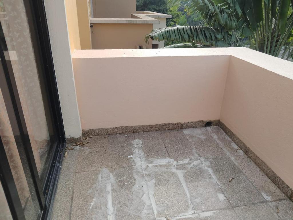 a door with graffiti on the floor next to a window at Surabhi Gardenia 28B-C in Raichak