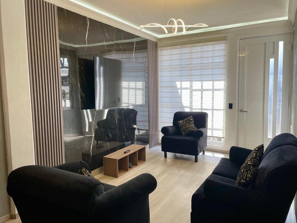 a living room with two couches and two chairs at Moderno departamento en Tula in Tula de Allende