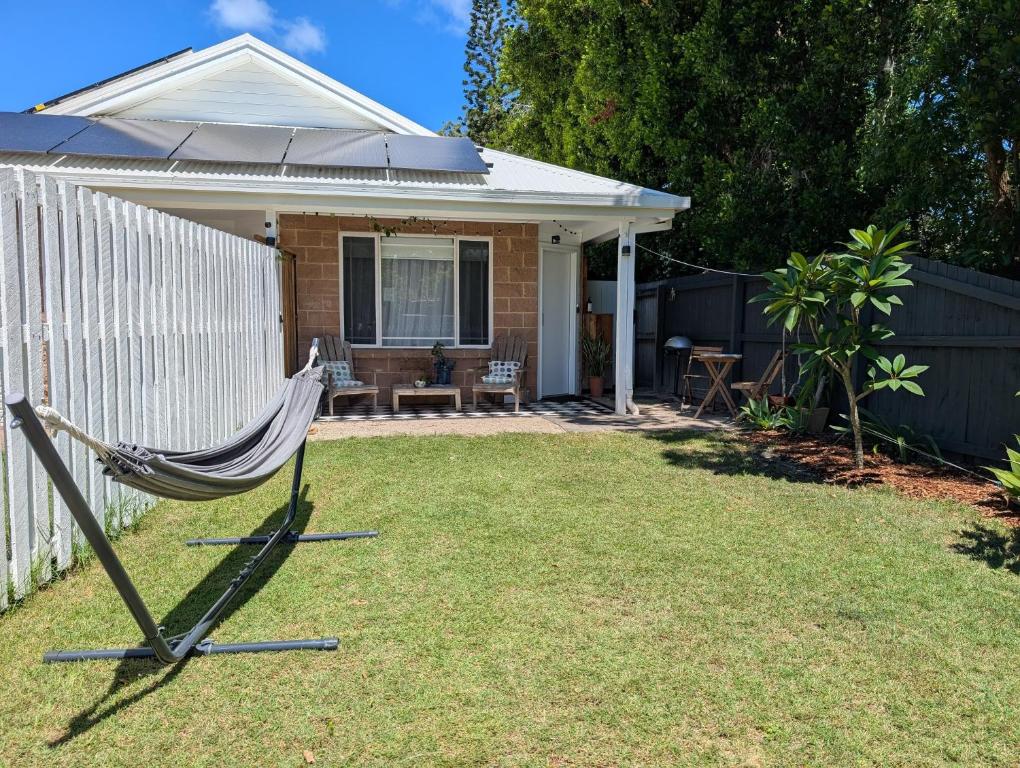 a hammock in the backyard of a house at Private Garden Studio - Walk to Beach in Byron Bay