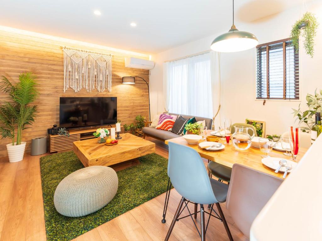 a living room with a table and a couch at 巡り宿香西本町-最大10名 in Takamatsu
