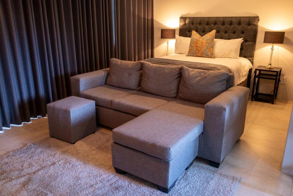a living room with a couch and a bed at Harmony House in Ladysmith