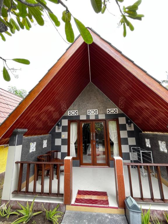 a small house with a red roof at MAHADING cottages in Gili Meno