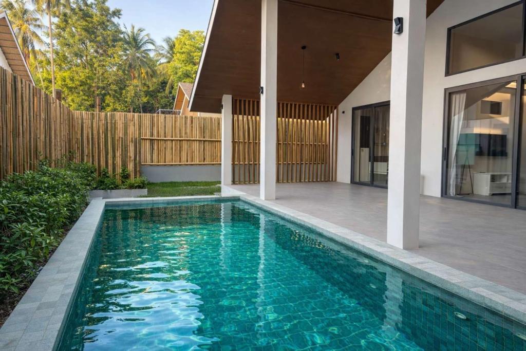 a swimming pool in the backyard of a house at Cocolane Villa 4 in Hinkong