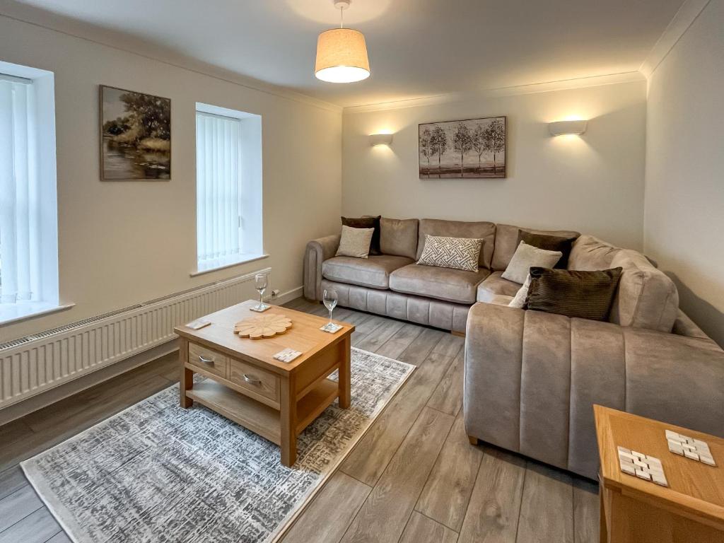 a living room with a couch and a table at Taigh-Beag - Uk50660 in Wigtown