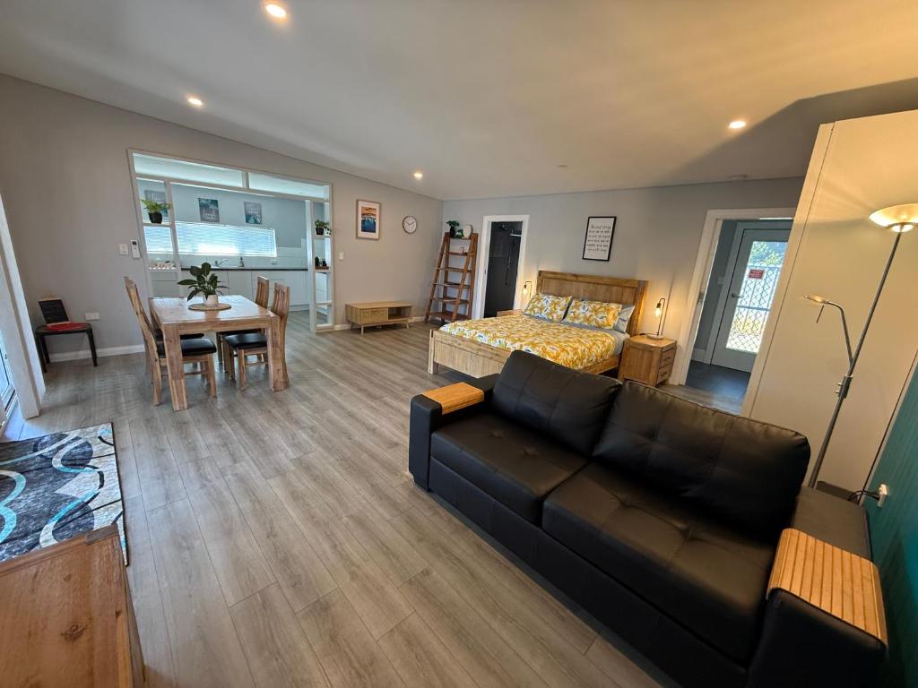 a living room with a couch and a bed and a table at Boyanup West Wing in Boyanup