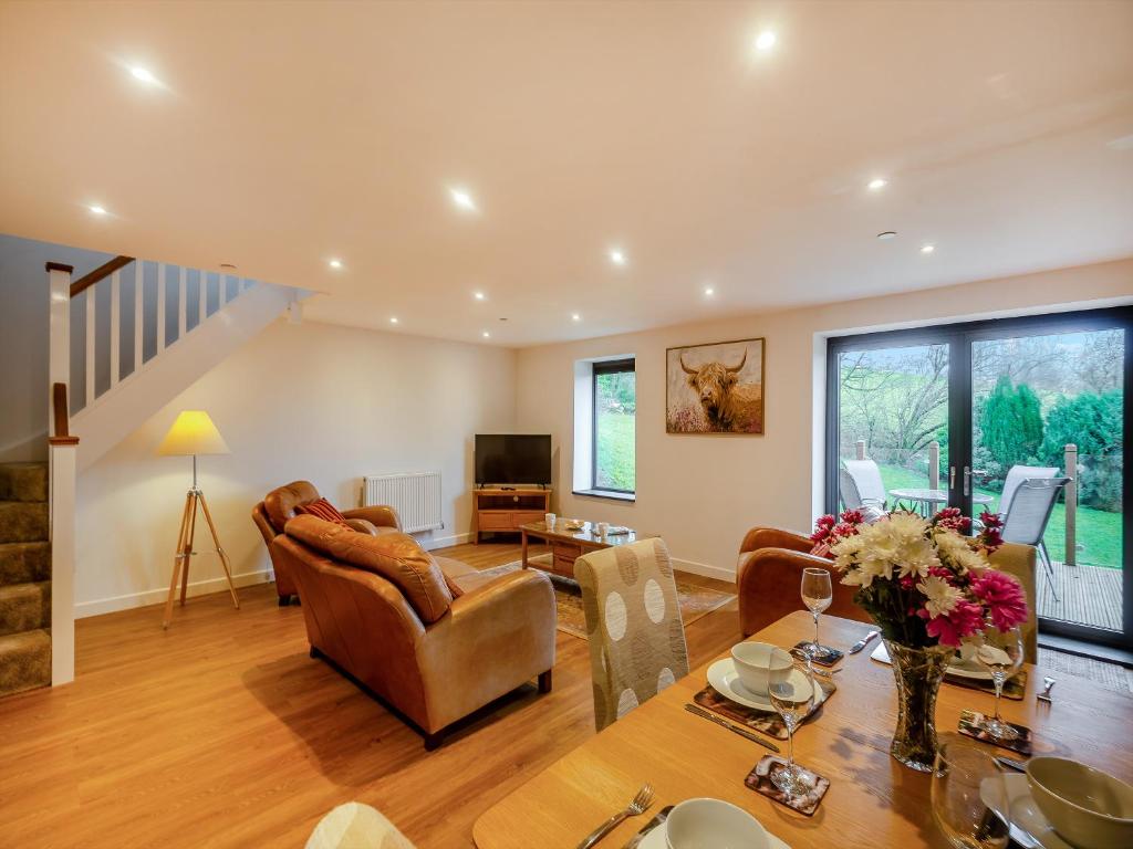a living room with a table and a couch at The Aran - Uk51067 in Frongoch