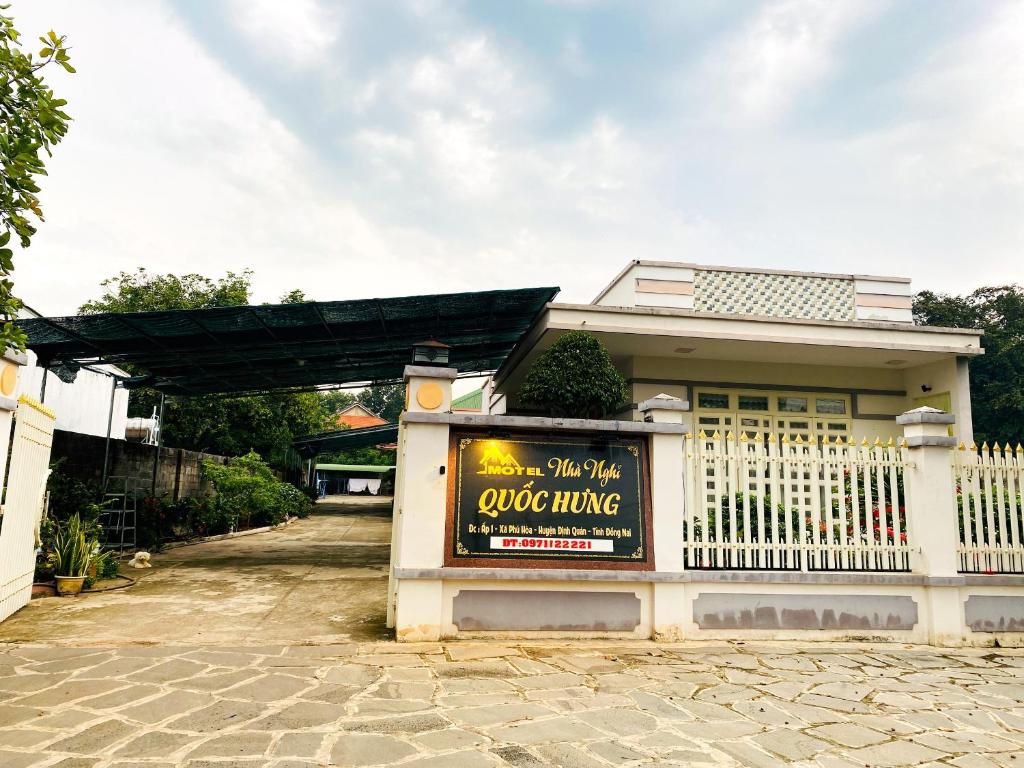 a building with a sign in front of it at Quốc Hưng in Ấp Trà Cô