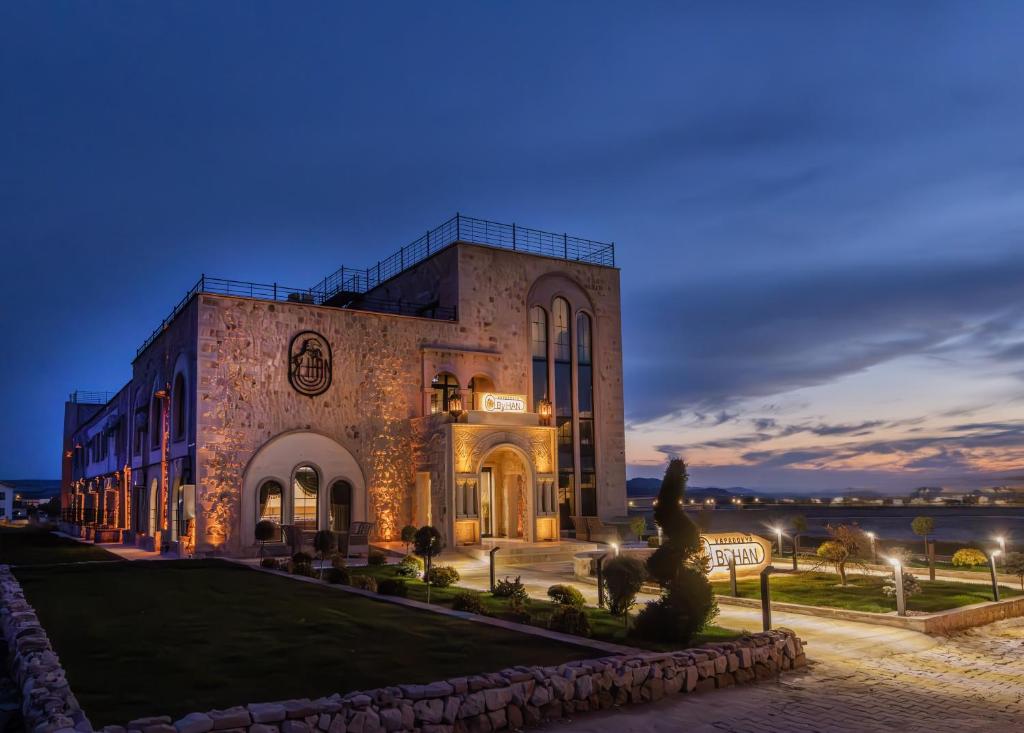 a building with a statue in front of it at Cappadocia ByHan Hotel - Special Class in Uçhisar