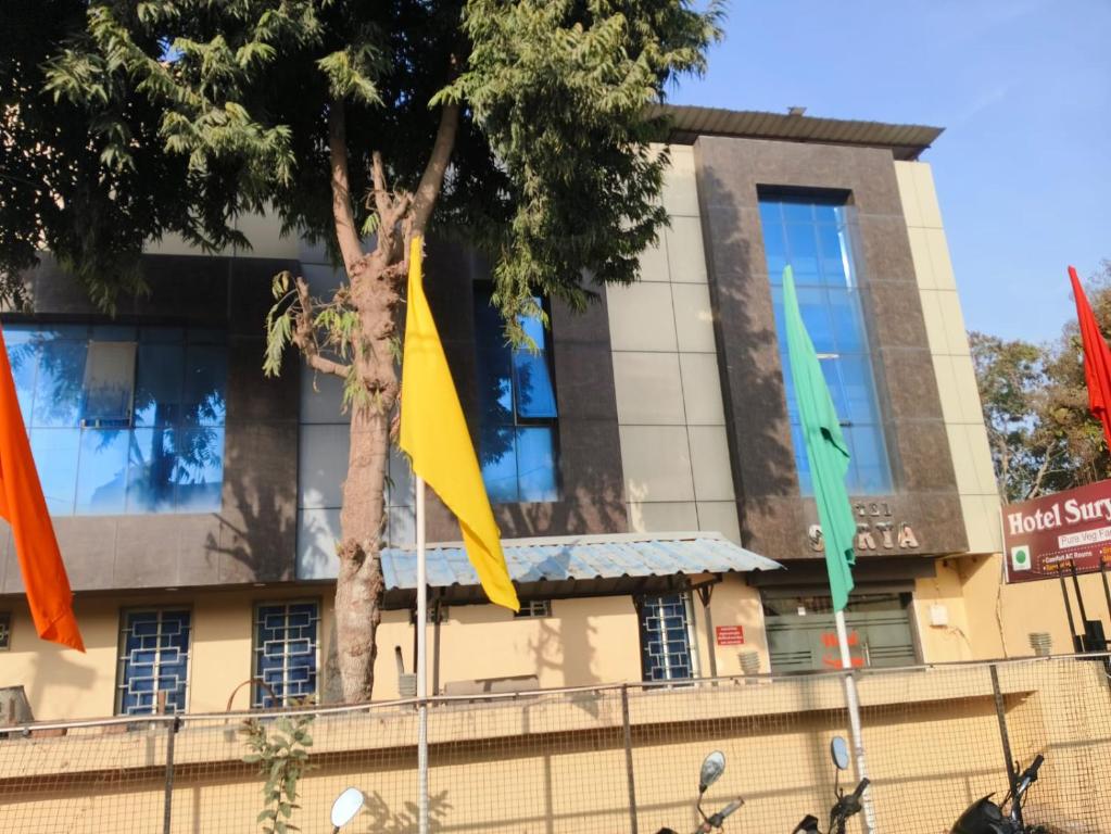 a building with flags in front of it at Hotel Surya in Datia